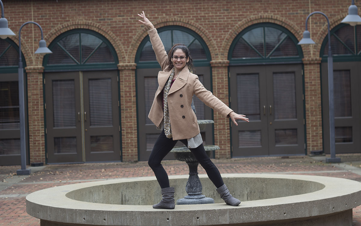 Photo of Jessica Gregory in a ballerina pose. She has brown hair and glasses.