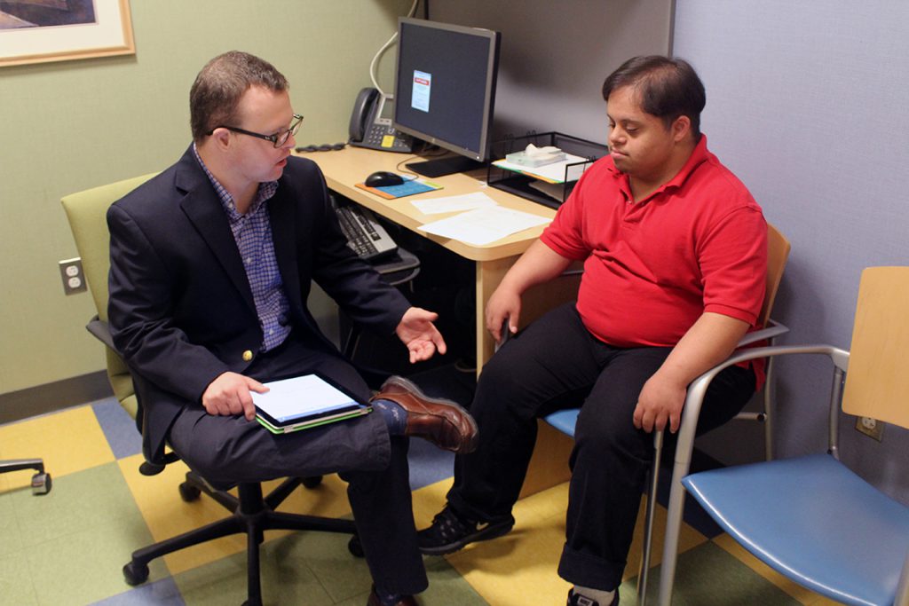 Two men with Down syndrome in a meeting.