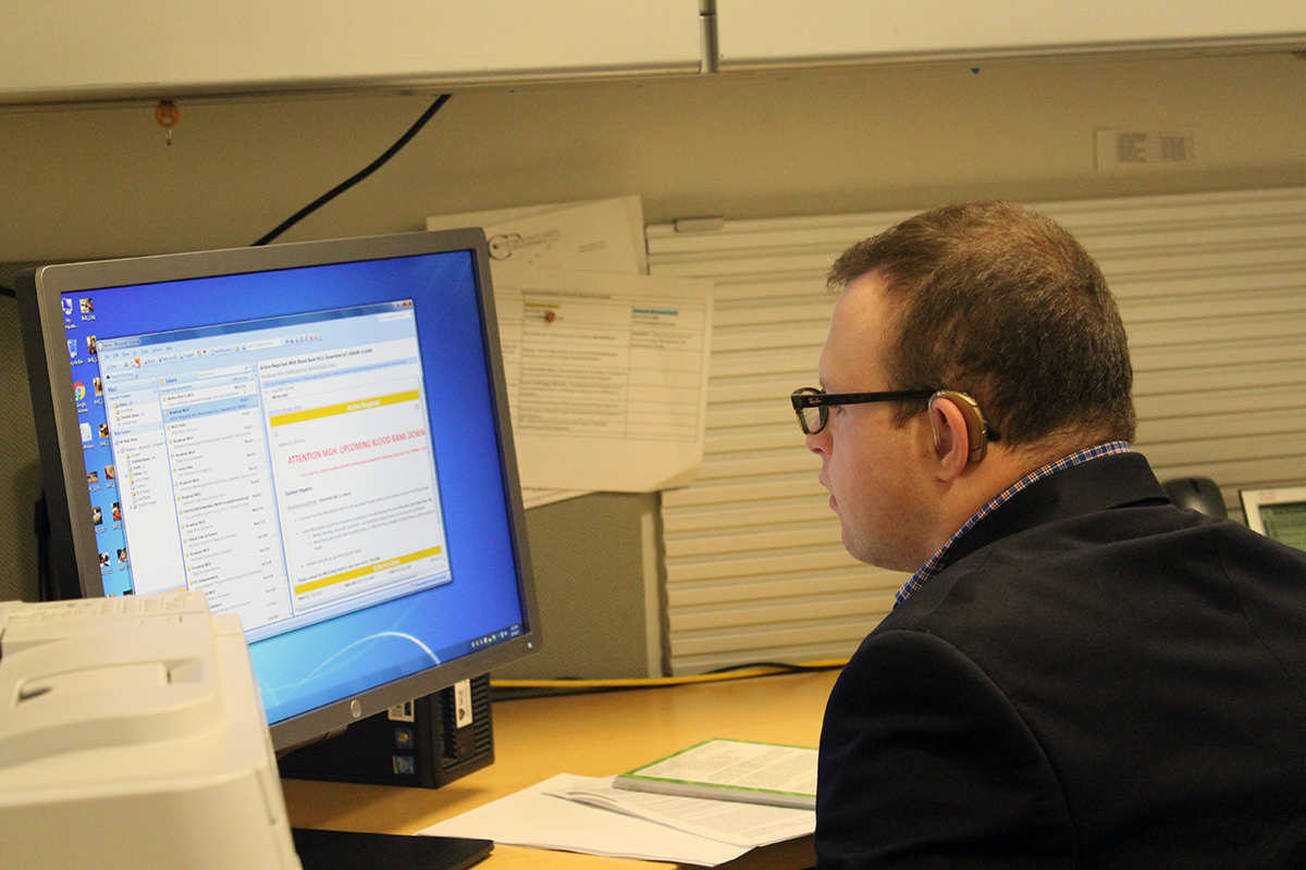 Man with Down syndrome working at a computer.