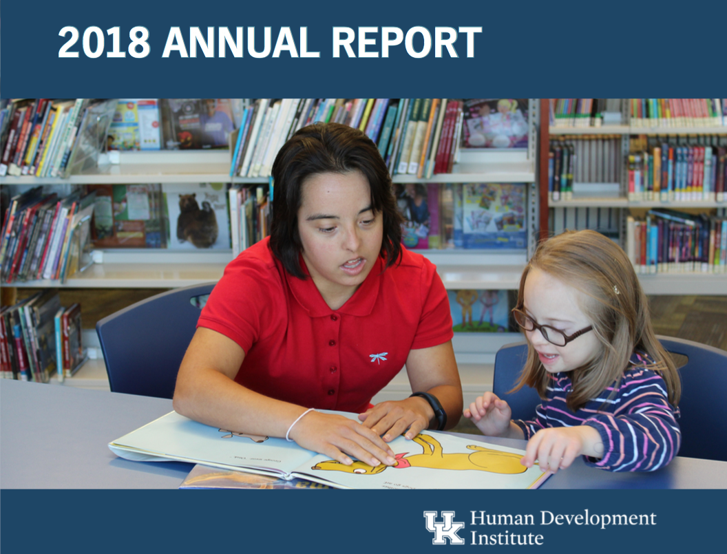 HDI Annual Report cover with Megan McCormick teaching Dailey how to read.