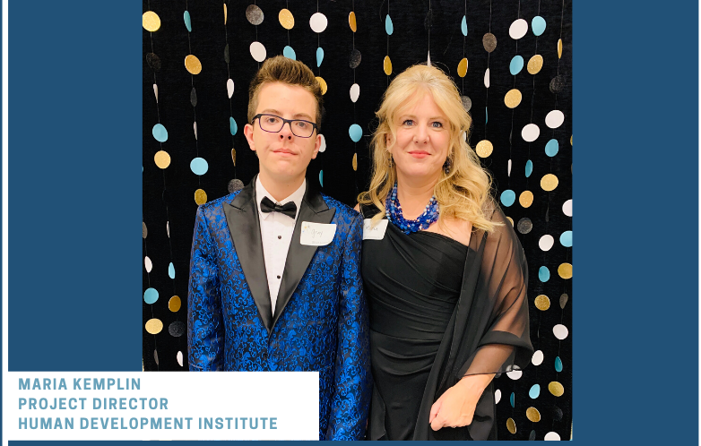 Woman and young man standing in front of wall decorated with circles