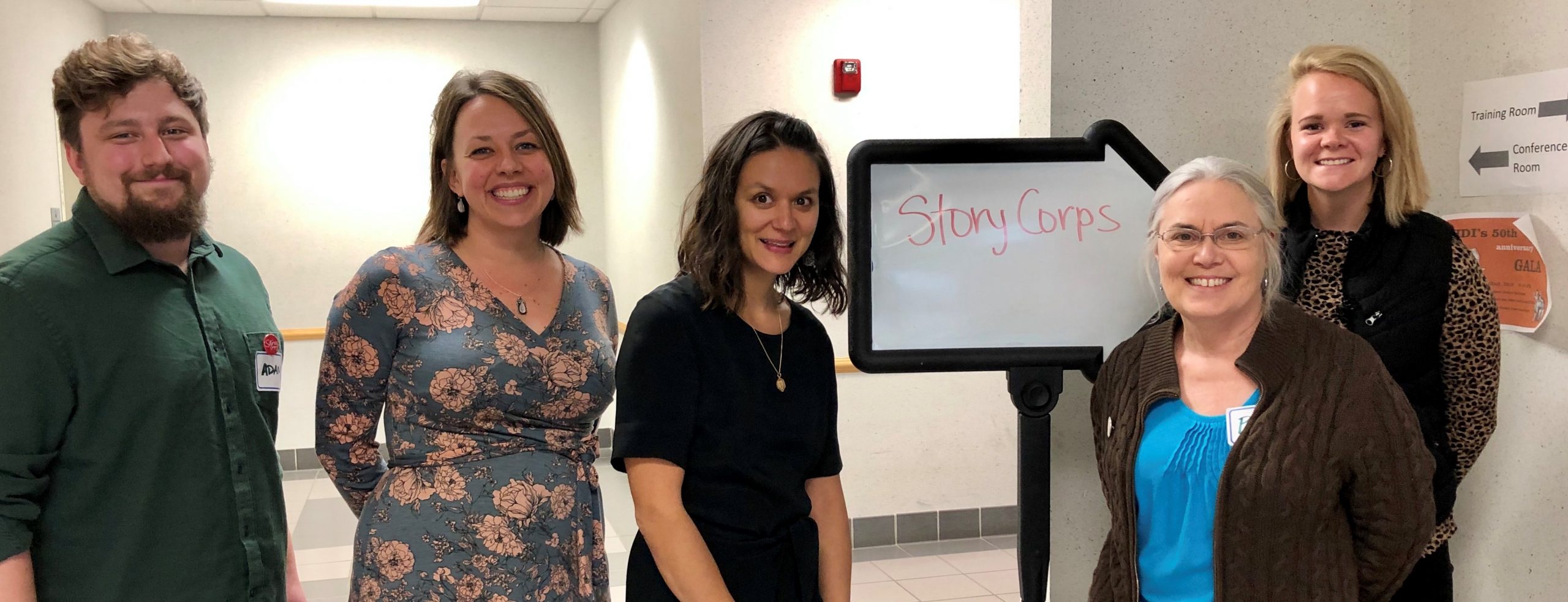 5 people standing in a training room