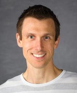 headshot of Ryan Hargrove. He has short, brown hair and is wearing a white and grey striped t-shirt.