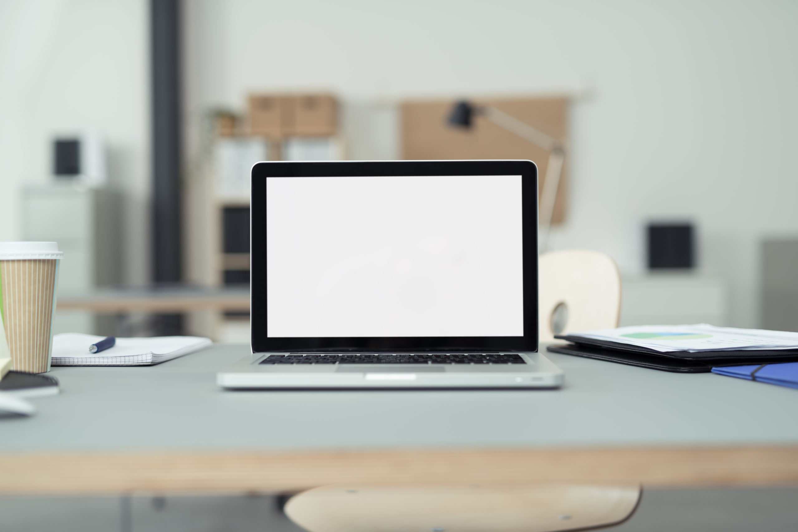 laptop sitting on a desk with blurred background