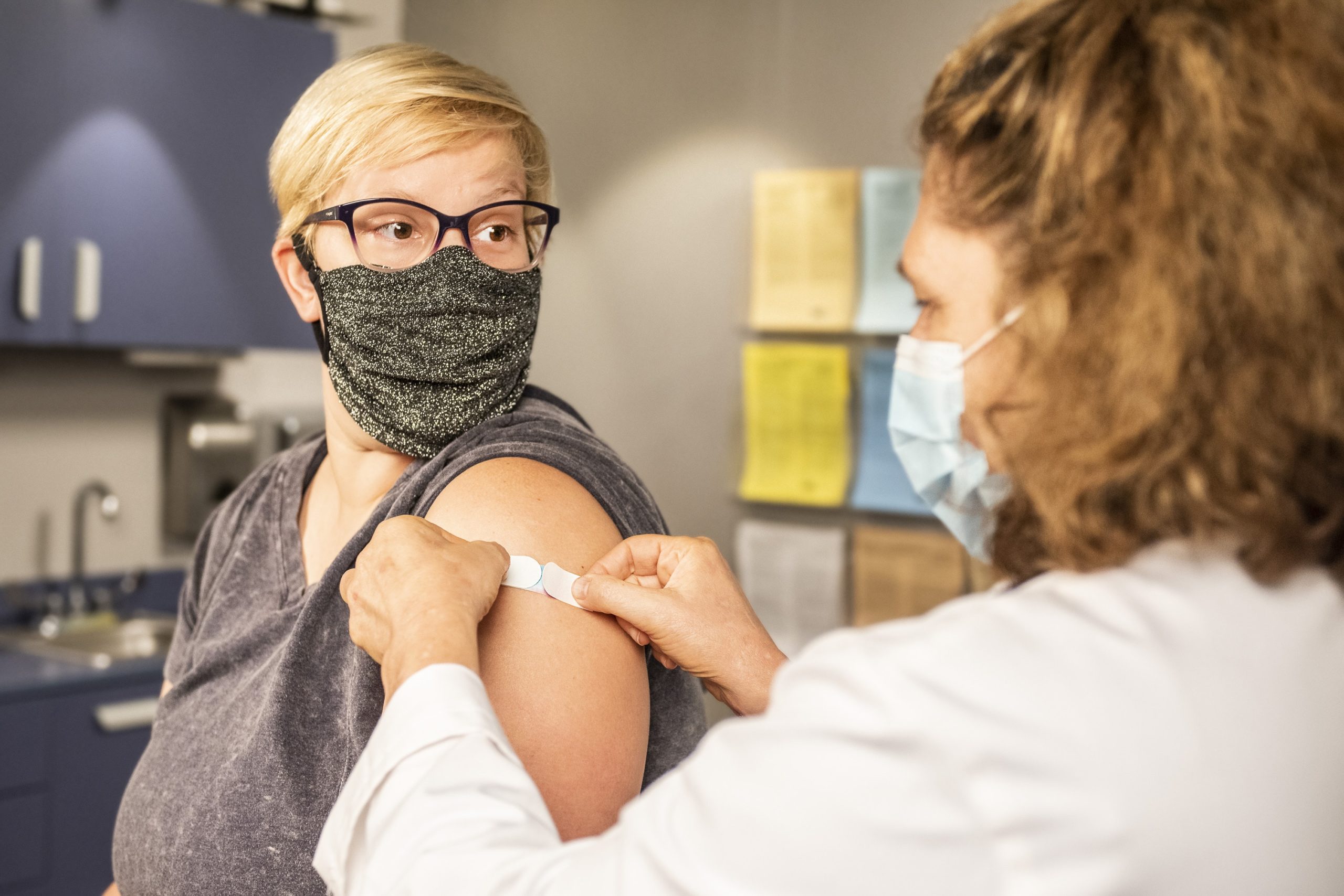 Woman getting a bandage after shot